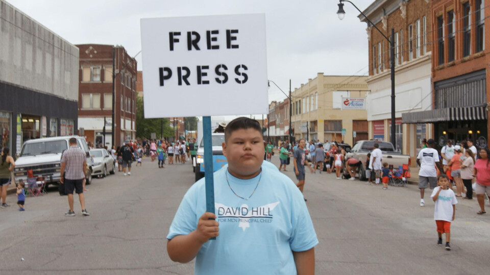 A member of the Muscogee Nation protests the government's actions against the press.