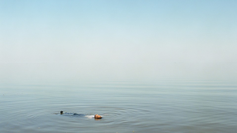 "Boy Floating in Water" by Ron Jude is featured in the "Ron Jude: Lago" exhibition at Sheldon Museum of Art.