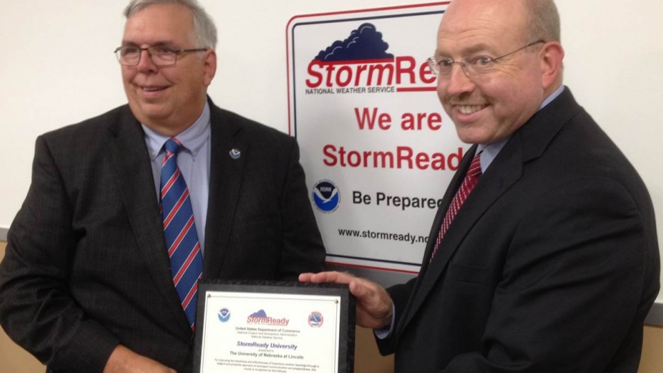 UNLPD Chief Owen Yardley (right) accepts the StormReady certification from Brian Smith, warning coordination meteorologist with the National Weather Service, on Aug. 12. The certification was earned through a year-long review of UNL's severe weather alert and response system.