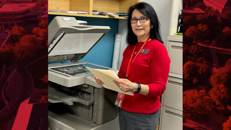 Annette Contreras stands next to the copy machine in the CAPS office.