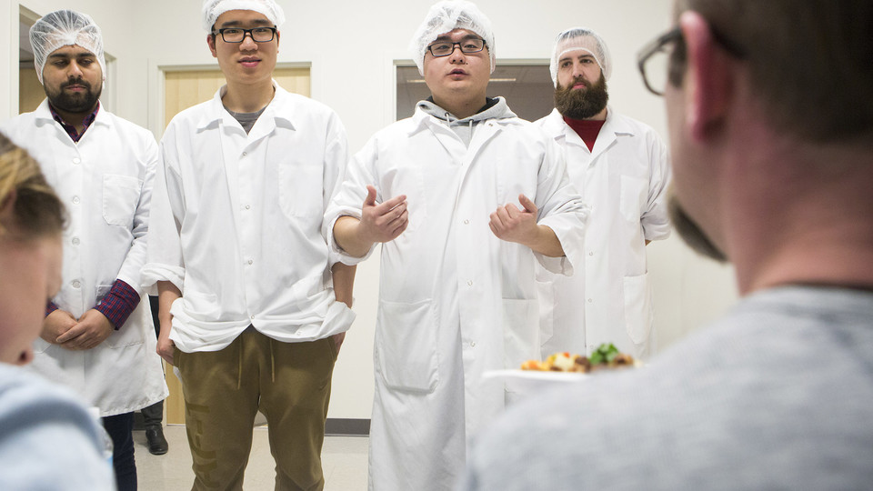 A Battle of the Food Scientists team present their pasta dish to judges during the Feb. 28 event. Pictured are team members (from left) Tushar Verma, Xinyao Wei, Long Chen and Jared Kleine.