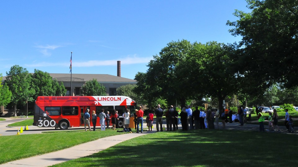A crowd listens as civic leaders announce the addition of five new StarTran buses that will run on compressed natural gas. The buses will run on the two routes that serve UNL.