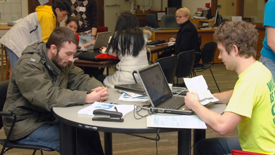 Volunteers assist with federal and state tax form preparation during a session offered at UNL. The university has offered the free service for eight years.