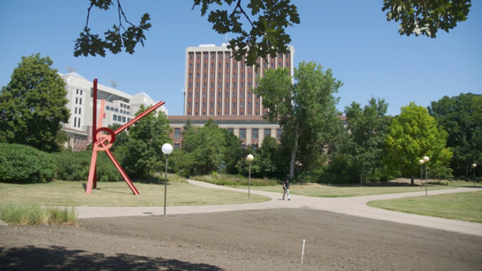A student passes through UNL's Cather Garden on July 31. The south quadrant of the garden is being renovated this summer. The other parts of the space will be updated as part of the Love Library North Learning Commons project.