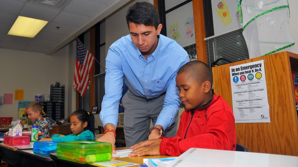 UNL's Emanuel "Manny" Maldonado assists an Everett Elementary student with a math lesson on Sept. 10. Maldonado has worked at Everett for three years as a participant in America Reads, America Counts, a federal work-study program.