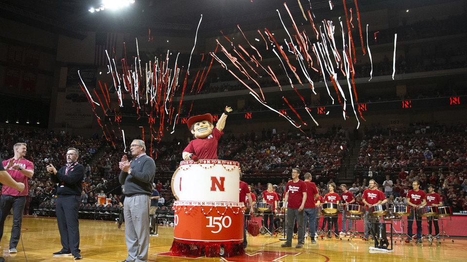 Herbie Husker pops out of a birthday cake during the halftime celebration at Pinnacle Bank Arena on Feb. 13. Herbie was joined by Scott Frost, head coach of Husker football; Chancellor Ronnie Green; and Bill Moos, director of athletics.