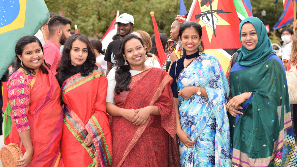 Students wearing traditional clothing from Bangladesh during the 2021 Homecoming Parade gather for a group photo. All students with traditional clothing from their country or heritage are invited to volunteer as models for the Mar. 26 Global Glam fashion show. 