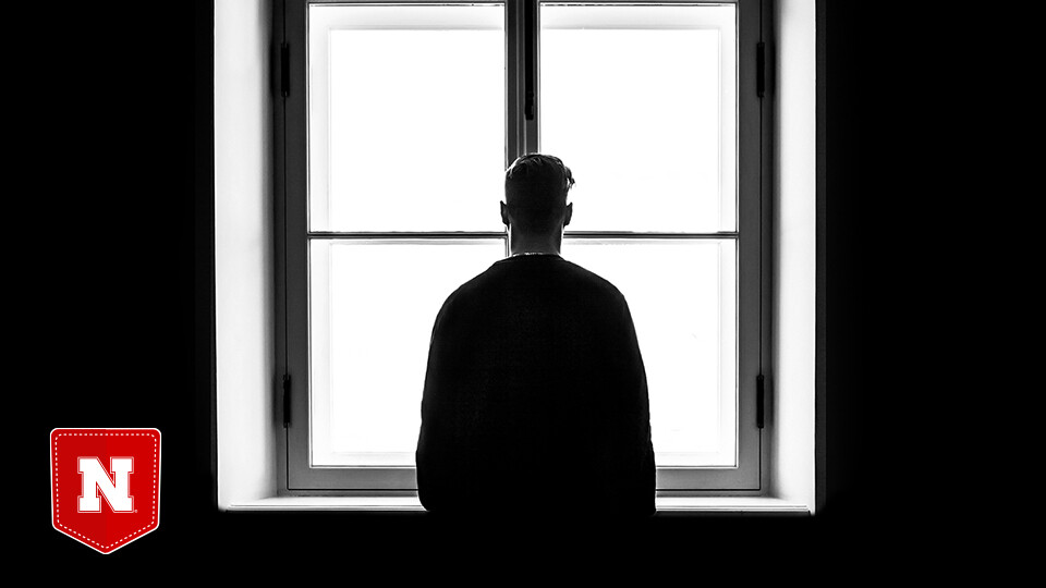 Person standing in front of high-contrast window