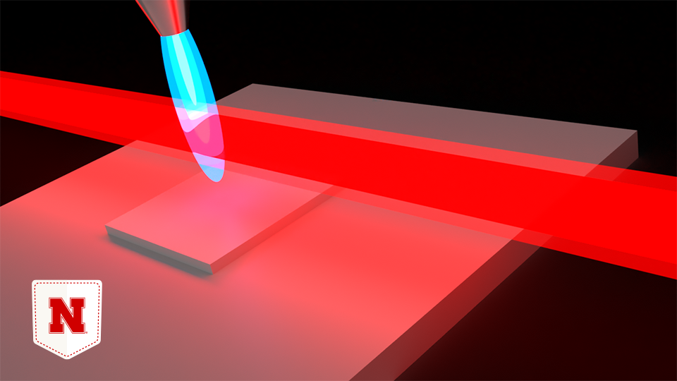 A rendering of an infrared laser striking a flame. Husker researchers have shown how a laser can modify chemical reactions taking place within a flame, allowing them to coat materials with performance-enhancing chemicals while avoiding an unwanted side effect that complicates the construction of semiconductors and other microelectronic components.