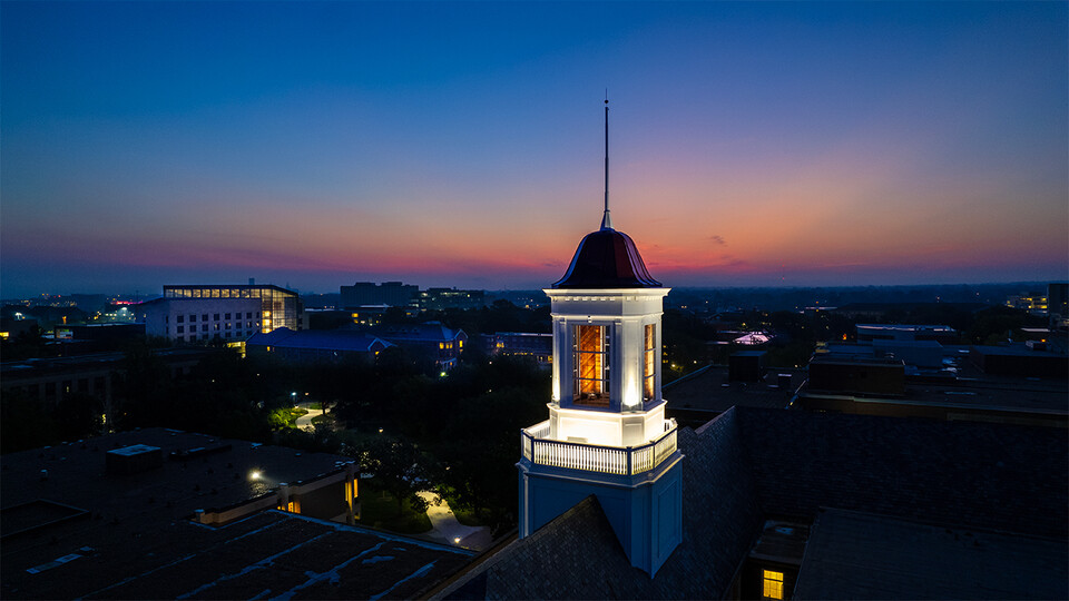 The cupola of Love Library looms above City Campus as the sun rises on the first day of the fall semester