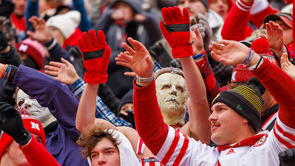 Payton Craw and Wesley Helmer wear Michael Myers masks while standing in the student section at Memorial Stadium