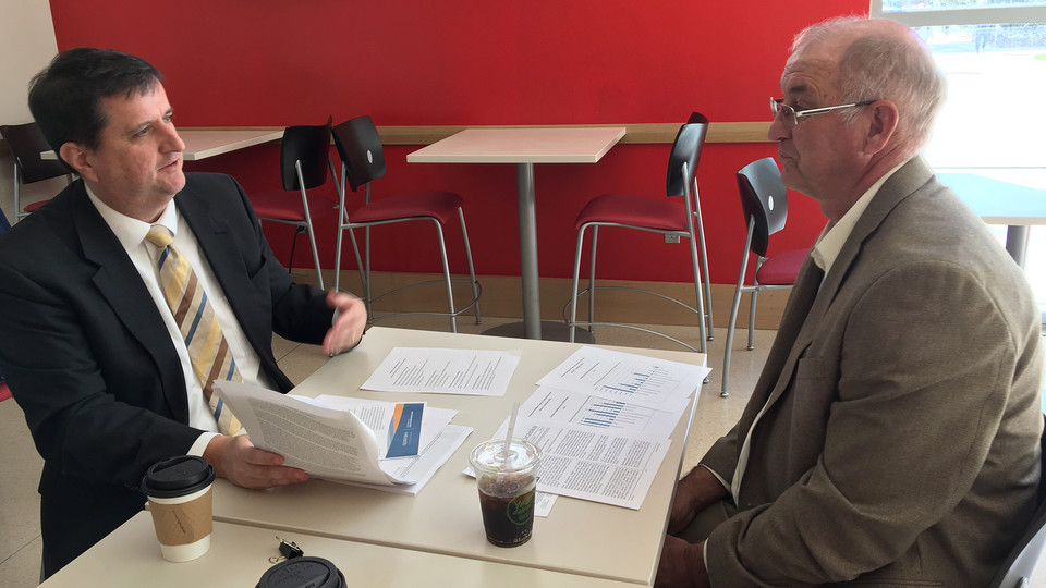 District 30 candidate and Nebraska alumnus Myron Dorn (right) visits with Eric Thompson in Howard Hawks Hall on Oct. 19. Dorn toured campus to learn more about how the university serves students and the state.