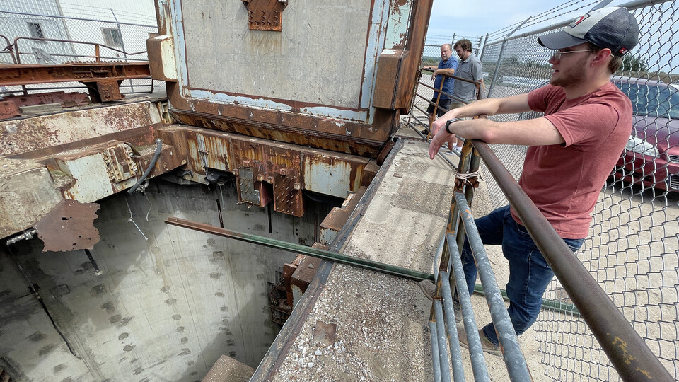 Nebraska's David Harwood (third from right) and students examine the exterior of the silo, and look down into the base.