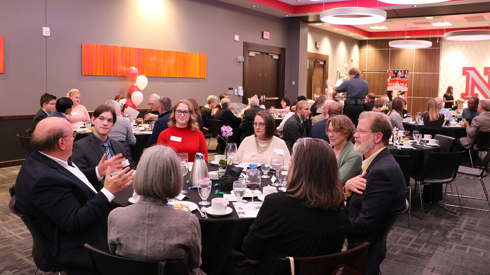 Students, faculty, alumni and members of the Lincoln-area community talk during the University Honors Program event on Oct. 28. More than 80 attended the fundraiser.