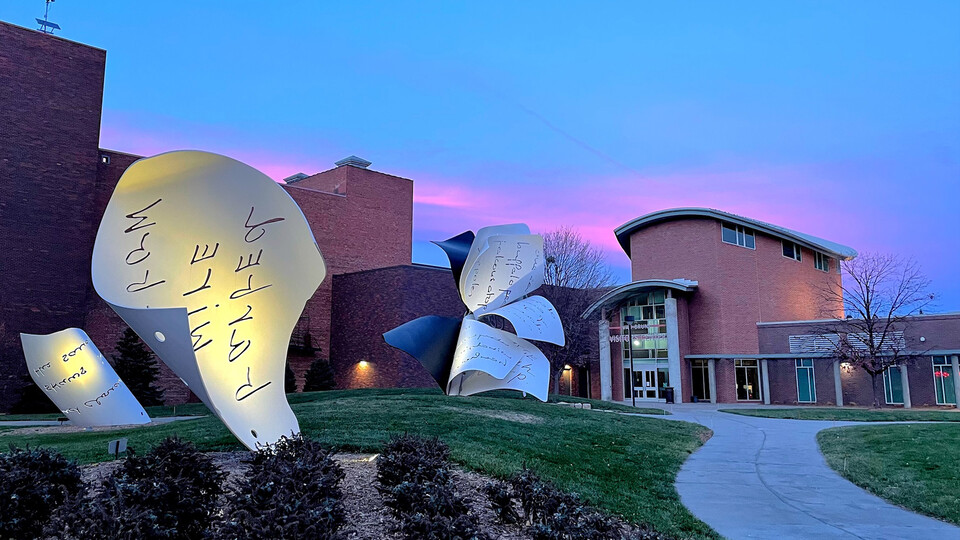 The sunset is reflected off the "Torn Notebook" sculpture, Van Brunt Visitors Center and easterly clouds on Dec. 14. The forecast for Dec. 15 is calling for wind gusts over 50-plus miles per hour, prompting an adjustment to the university's saliva-based COVID-19 testing.