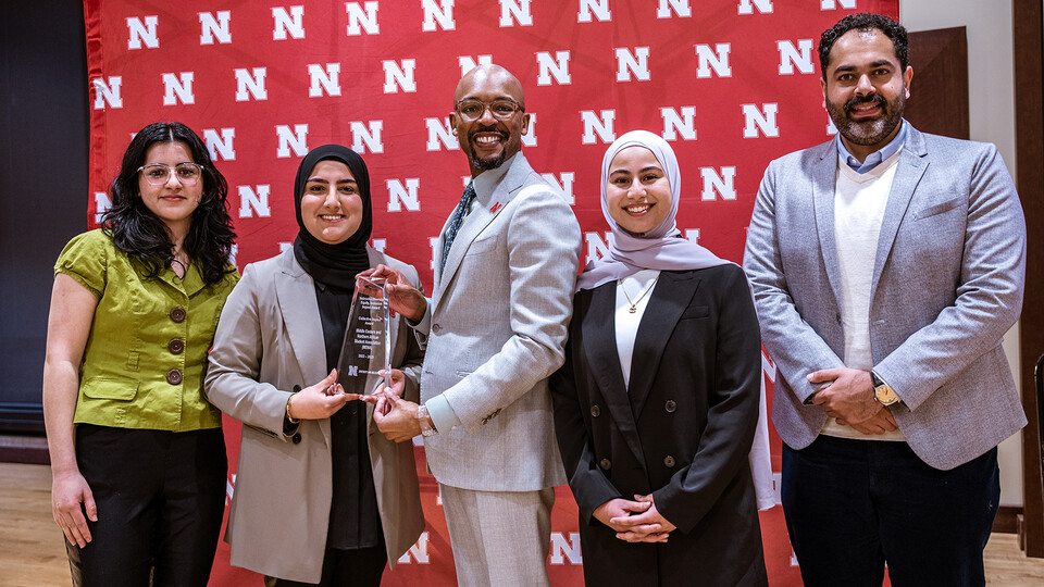 MENA members accept the Collective Impact award from Marco Barker (center), vice chancellor of diversity and inclusion. Pictured with Barker is (from left) Shahla Abrahim, Furqan Mahdi, Sara Al-Rishawi and Hassan Almokhreq.