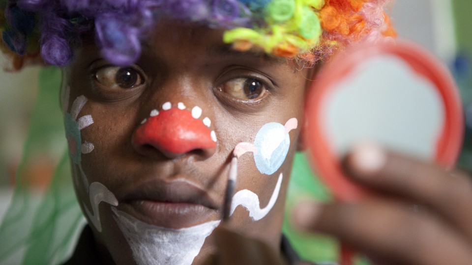 Birhanu Taddese applies clown make up before working at the pediatric ward at the Black Lion Hospital in Addis Ababa, Ethiopia. Photos like this one were taken by 12 UNL photojournalism students who spent three weeks in Ethiopia developing content for a new depth report.