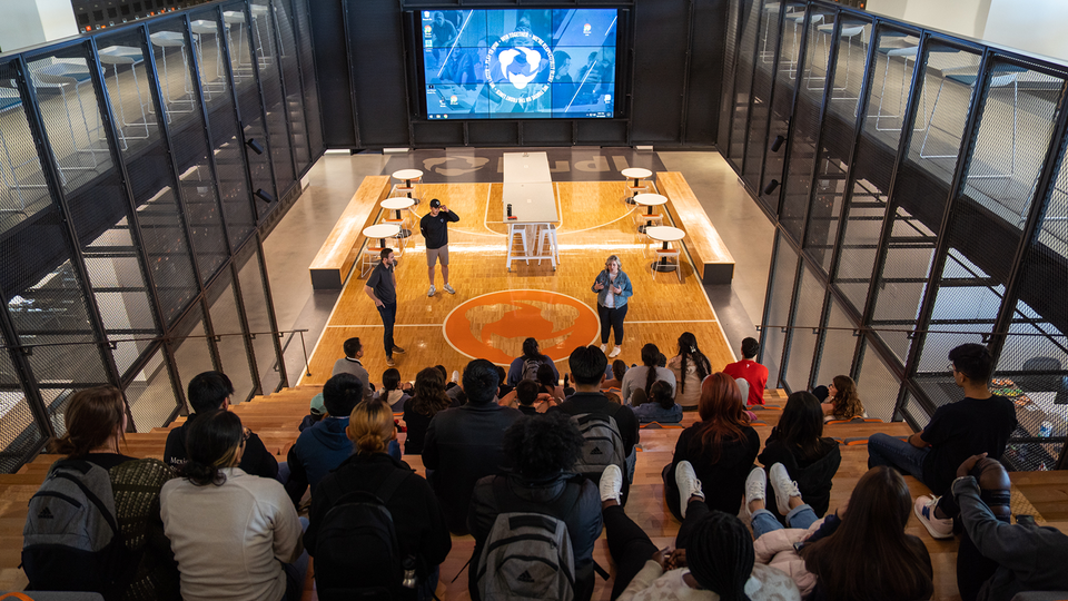 Nebraska College Preparatory Academy Scholars listen to Hudl's chief operating officer, Matt Mueller, and recruiters tell the company's story during a visit to Hudl on Oct. 13.