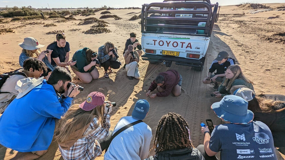 Students on a study abroad trip in Namibia focus on a web-footed palmetto gecko while on a study abroad trip in Namibia. The trip is led by Larkin Powell, professor of natural resources and interim associate director of the College of Agricultural Sciences and Natural Resources.