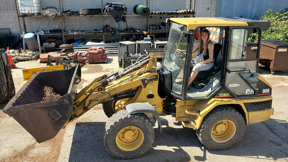 Amber Reinkordt behind the wheel of one of her favorite pieces of work machinery, a Caterpillar 906.