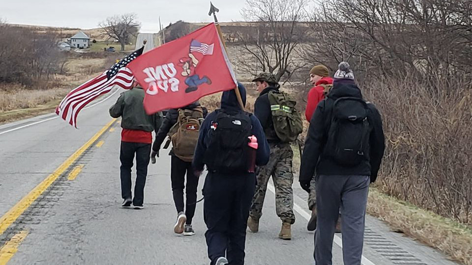 Members of the Nebraska Student Veteran Organization walk along an Iowa highway on Nov. 26 as part of the Things They Carry Ruck March. The event, organized by Nebraska and Iowa students, is designed to raise public awareness of veteran suicides.