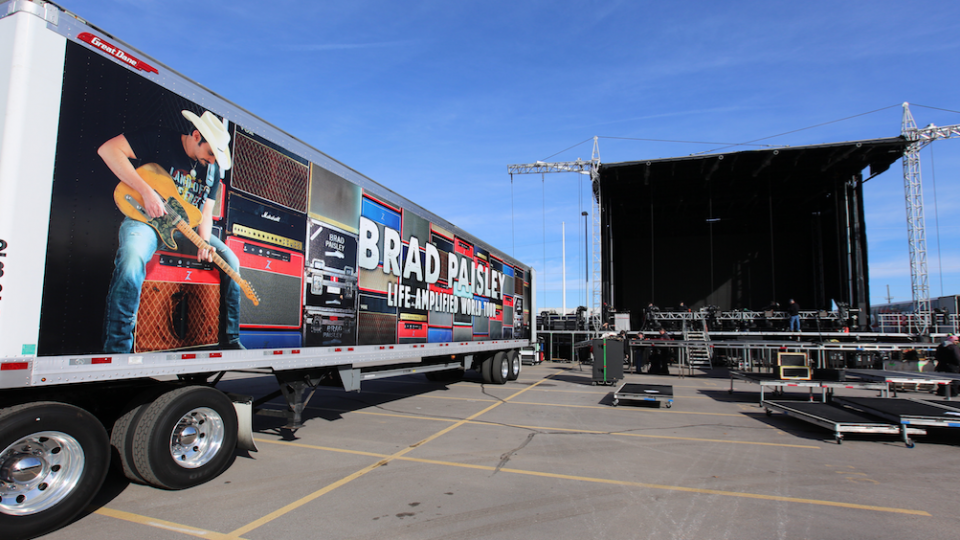 Crew members set up the stage for the Brad Paisley concert in the parking lot immediately north of Memorial Stadium. A crew of more than 30 started setting up the stage at 8 a.m. and should complete the work around noon.