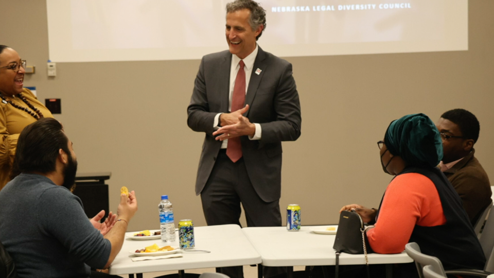 Richard Moberly, dean of law, talks with students during a college event.