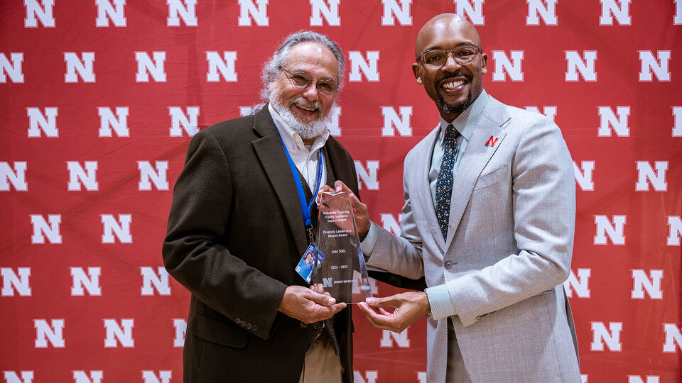 Jose Soto accept the Diversity Leadership Alumni award from Marco Barker, vice chancellor of diversity and inclusion.