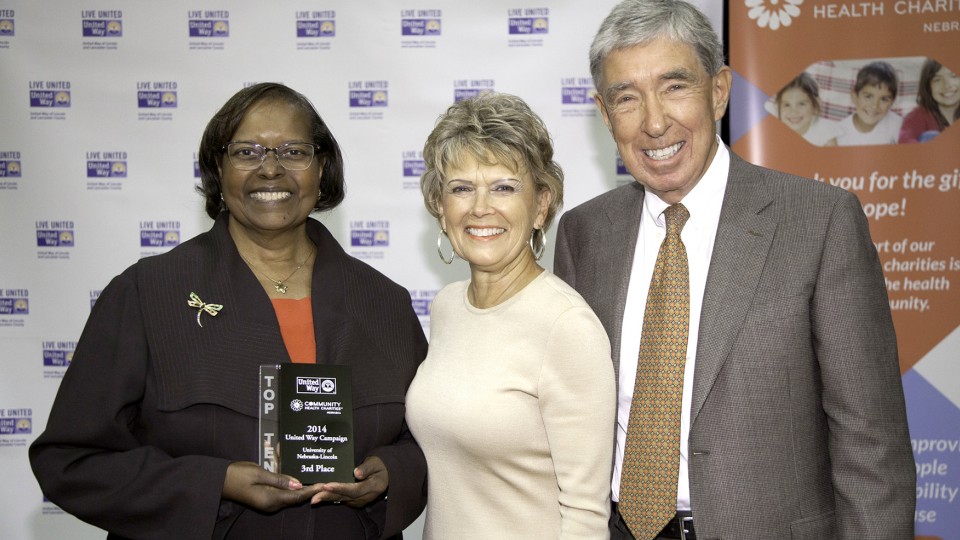 Colleen Jones (from left), associate professor of practice in management, accepts UNL's third-place award from 2014 United Way Campaign co-chairs Linda Robinson Rutz and Philip Mullin. The award was presented May 8.