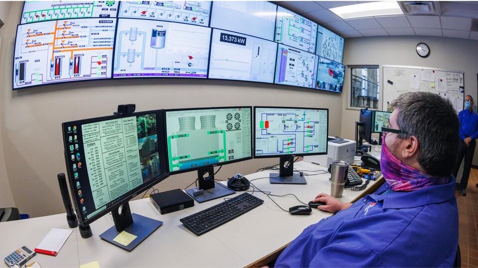 Man monitoring screens with utilities information