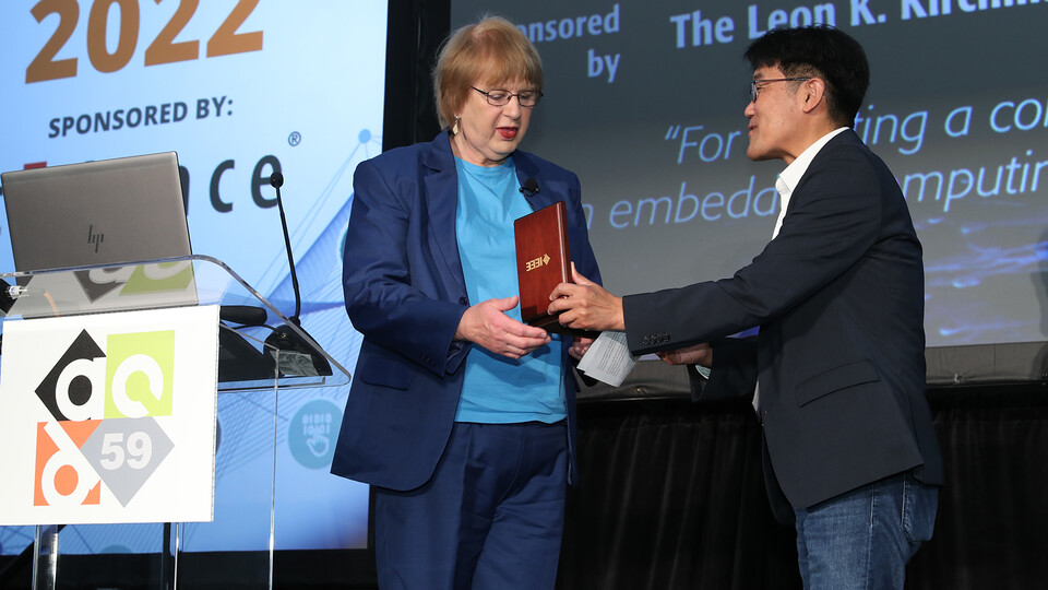 Nebraska's Marilyn Wolf, director of the School of Computing, accepts the IEEE award from Gi-Joon Nam during a ceremony in July. The award celebrated Wolf's dedication to graduate student education.