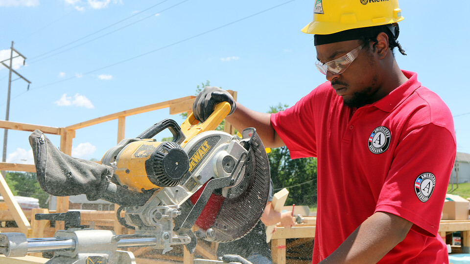 An AmeriCorps member works on a project in Omaha.