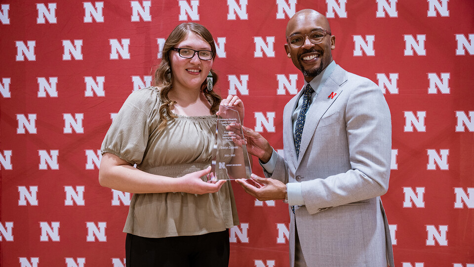 Daelyn Zagurski accepts the Promising Leader: Undergraduate Student award from Marco Barker, vice chancellor of diversity and inclusion.