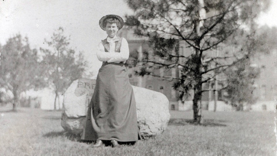Willa Cather poses in front of an engraved boulder on the University of Nebraska campus in the early 1890s. Scholars from around the world will be at UNL June 8-12 to attend the 15th International Cather Seminar.
