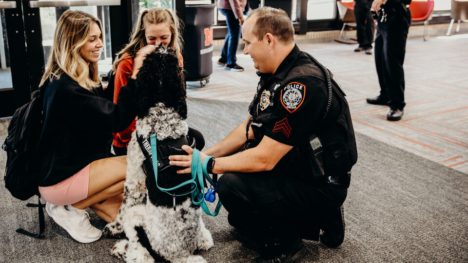 campus police and dog with students