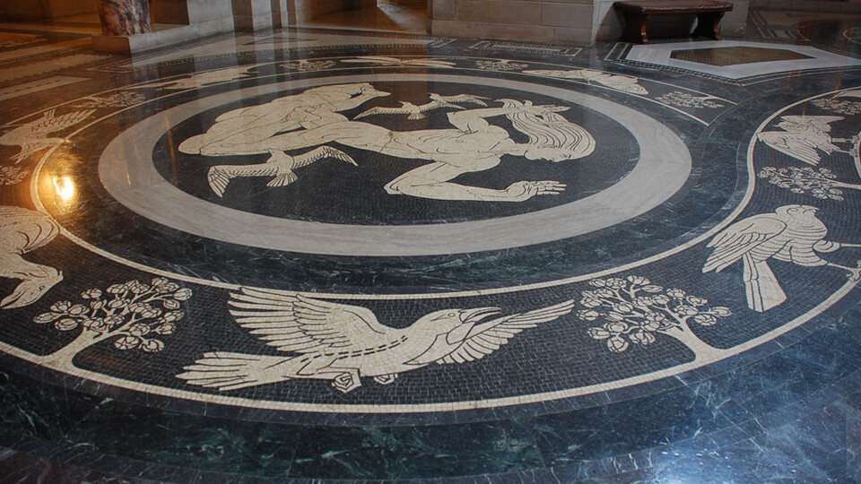 The Rotunda floor features bands around the main medallions, which contain images or prehistoric life found in Nebraska. 