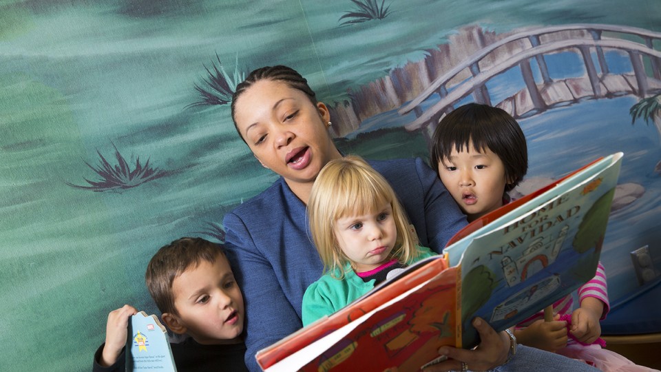 Tonia Durden reads to children and student teachers at UNL's Ruth Staples Center. The assistant professor was honored by the USDA for her contributions in family life and human development.