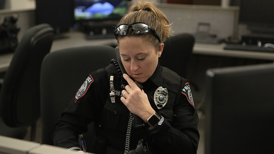 Nebraska's Marissa James takes a call while on duty with the UNL Police Department. James has served as a university police officer since April 2020.