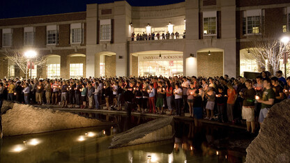 Students stand around Broyhill Fountain outside the Nebraska Union during a 2007 candlelight vigil held in response to a campus shooting at Virginia Tech. UNL will host an April 10 memorial at Broyhill Fountain to celebrate the lives of students who have died this academic year.