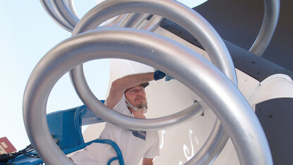 Michael van Enter removes a smudge from UNL's "Torn Notebook" sculpture during a renovation in June 2007. The iconic UNL sculpture was created by Claes Oldenburg and Coosje Van Bruggen.