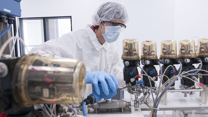 A member of UNL's Biological Process Development Facility examines equipment in 2012. The facility, located in Othmer Hall, has created a cream with the potential to block HIV transmission in women.