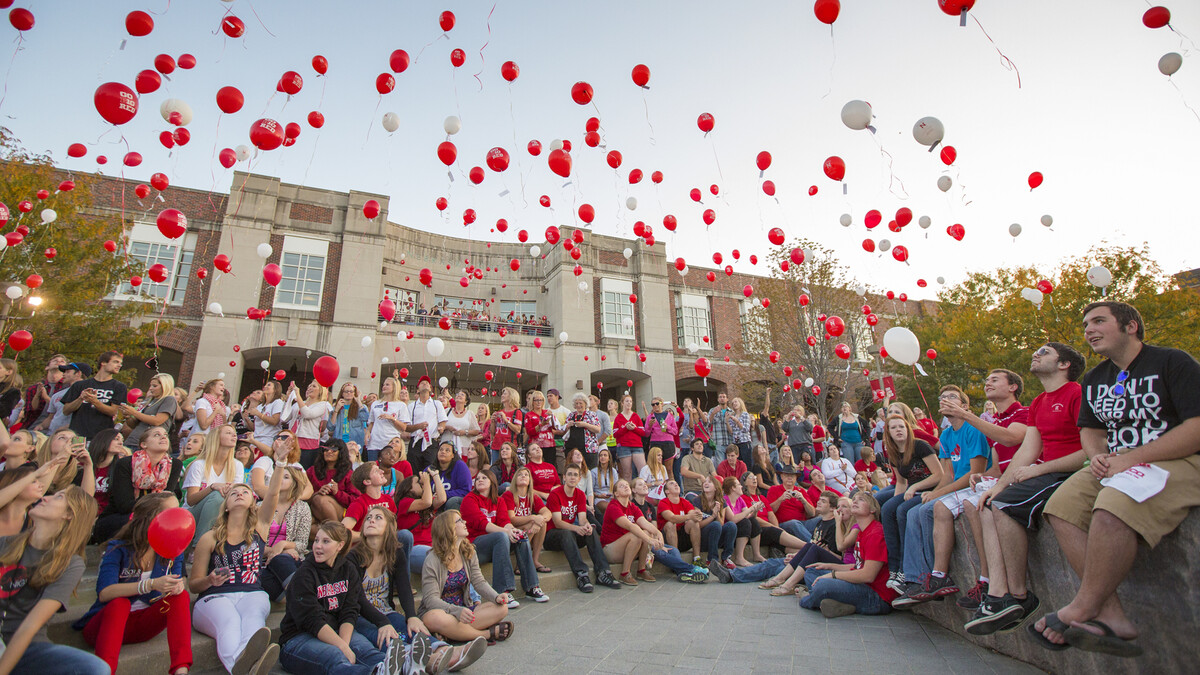 Husker fans release balloons during the 2012 UNL Homecoming pep rally outside the Nebraska Union.