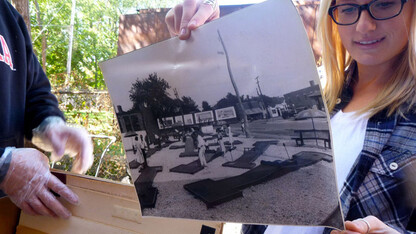 A student examines a photo during a UNL History Harvest event in Omaha. The third annual History Harvest is March 15.