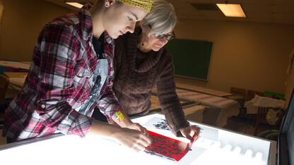 Wendy Weiss (right) works with a student in a Textiles, Merchandising and Fashion Design studio. Weiss received a second Fulbright that will allow her to expand research into the ikat weaving method.