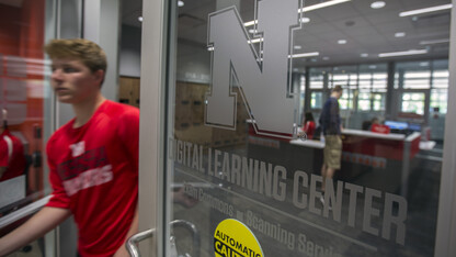 A student passes through the door to the Digital Learning Center after completing a final exam on May 4.