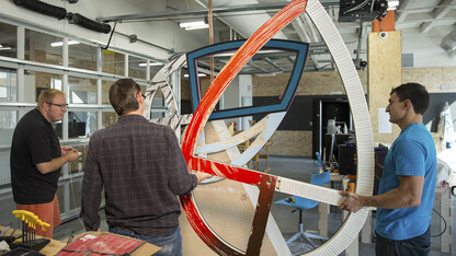 Members of the UNL Maker Club assemble the sculpture that will cut the ribbon during the Oct. 8 grand opening at Nebraska Innovation Campus. The project included 14 members of the UNL Maker Club planning and creating the sculpture at NIC's Nebraska Innovation Studio.