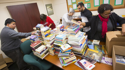 Members of UNL's Institute for Ethnic Studies box up donated books prior to sending them to the Ferguson Municipal Public Library. More than 600 books were collected for campuswide effort.