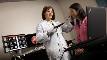 Angela Dietsch uses a scope to image a client’s throat in her lab in the Barkley Memorial Center. Dietsch, an assistant professor of special education and communication disorders, is among faculty who have earned national awards in recent years, having been selected for an American Speech-Language-Hearing Association Early Career honor. 