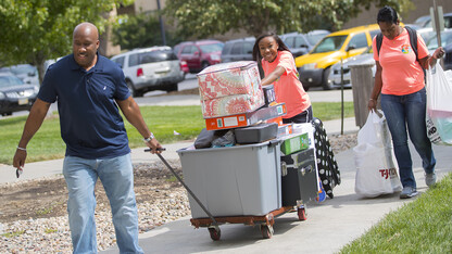 Erin Hunter tries to keep everything balanced as her parents help during the 2016 move-in to Nebraska residence halls.