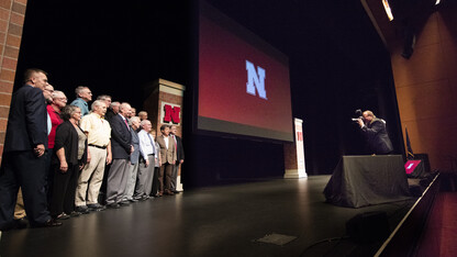 Employees honored for their years of service to the university pose for a photo on stage during the Sept. 22 State of the University address. More than 890 employees are receiving awards for their years of service in 2016.